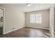 Bedroom featuring hardwood floors and natural light from large windows at 1932 Rosewood Rd, Decatur, GA 30032