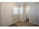 Neutral entryway with tile and carpet flooring, features a conveniently located half bathroom and two entry doors at 1932 Rosewood Rd, Decatur, GA 30032