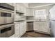 Modern kitchen featuring stainless steel appliances, white cabinets, and sleek countertops at 1932 Rosewood Rd, Decatur, GA 30032