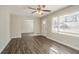 Bright living room featuring hardwood floors, ceiling fan and plenty of natural light from large windows at 1932 Rosewood Rd, Decatur, GA 30032