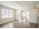 The spacious living room has large windows providing ample natural light and beautiful wood laminate flooring at 1932 Rosewood Rd, Decatur, GA 30032