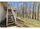 View of wooden steps leading to backyard that features wooded and natural areas at 67 Oak Landing Way, Douglasville, GA 30134