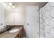 Bathroom featuring granite topped vanity, updated fixtures, and tub shower combo at 67 Oak Landing Way, Douglasville, GA 30134