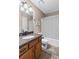 Well-lit bathroom featuring a granite countertop, wood cabinets, and shower-tub combination at 67 Oak Landing Way, Douglasville, GA 30134