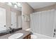 Well-lit bathroom featuring a granite countertop, wood cabinets, and shower-tub combination at 67 Oak Landing Way, Douglasville, GA 30134