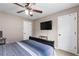 Neutral bedroom featuring a fan, a television, and dual closets, creating a modern and inviting space at 67 Oak Landing Way, Douglasville, GA 30134