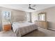Bright bedroom with a large window, ceiling fan, and classic wooden dresser at 67 Oak Landing Way, Douglasville, GA 30134