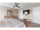 Spacious bedroom featuring a ceiling fan, mounted TV, and classic wooden dresser at 67 Oak Landing Way, Douglasville, GA 30134