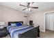 Comfortable bedroom with ample natural light, a ceiling fan, and carpeted flooring at 67 Oak Landing Way, Douglasville, GA 30134
