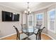 Bright dining area with a glass table, modern chairs, and large windows at 67 Oak Landing Way, Douglasville, GA 30134