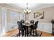 Cozy dining area features a granite table set with leather chairs and a chandelier at 67 Oak Landing Way, Douglasville, GA 30134
