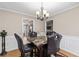 Bright dining area featuring a granite table with leather chairs under a chandelier at 67 Oak Landing Way, Douglasville, GA 30134