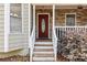 Inviting entryway featuring a decorative front door, stone accents, and classic railing at 67 Oak Landing Way, Douglasville, GA 30134