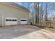 Spacious garage with two bay doors and ample parking space on a concrete driveway at 67 Oak Landing Way, Douglasville, GA 30134