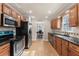 Functional kitchen with wood cabinets, black countertops, and stainless steel appliances at 67 Oak Landing Way, Douglasville, GA 30134