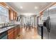 Open kitchen and dining area with wood cabinetry, granite countertops, and updated appliances at 67 Oak Landing Way, Douglasville, GA 30134
