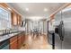 A bright kitchen has stainless steel appliances, wooden cabinets, and a cozy dining area bathed in natural light at 67 Oak Landing Way, Douglasville, GA 30134