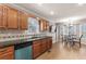 A kitchen features wooden cabinets, granite countertops, and stainless steel appliances, complemented by an adjacent dining area at 67 Oak Landing Way, Douglasville, GA 30134