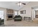 Bright living room featuring a stone fireplace, comfortable seating, and ample natural light at 67 Oak Landing Way, Douglasville, GA 30134