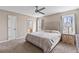 Spacious main bedroom features neutral walls, ceiling fan, carpet and an ensuite bath at 67 Oak Landing Way, Douglasville, GA 30134