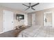 View of main bedroom showing ceiling fan, carpet, TV, and access to ensuite bathroom at 67 Oak Landing Way, Douglasville, GA 30134