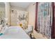 Bathroom with a marble countertop, patterned shower curtain and tiled shower at 69 Polar Rock Sw Rd, Atlanta, GA 30315