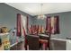 Bright dining room with a chandelier and large windows overlooking a fenced backyard at 69 Polar Rock Sw Rd, Atlanta, GA 30315