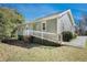 Charming home featuring a white-railed ramp, light green siding, and well-maintained yard at 69 Polar Rock Sw Rd, Atlanta, GA 30315