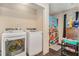 This laundry room has a washer, dryer, and a shelf at 69 Polar Rock Sw Rd, Atlanta, GA 30315