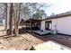 A backyard features a covered patio dining area, landscaping, fire pit, and exterior of the home at 975 Fox Valley Trl, Stone Mountain, GA 30088