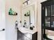 Bathroom featuring vanity with sink, framed mirror, storage shelves, and modern lighting at 975 Fox Valley Trl, Stone Mountain, GA 30088