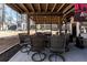 View of a covered patio with dining area, concrete flooring and an outdoor building in the background at 975 Fox Valley Trl, Stone Mountain, GA 30088