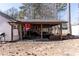 Covered patio with outdoor furniture and ceiling fan for relaxing at 975 Fox Valley Trl, Stone Mountain, GA 30088