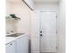 Well-lit laundry room with a washing machine and dryer and a storage shelf at 975 Fox Valley Trl, Stone Mountain, GA 30088