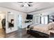 A main bedroom featuring wood floors, ceiling fan, and private access to the bathroom at 975 Fox Valley Trl, Stone Mountain, GA 30088