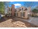 Inviting two-story home with a brick chimney, neutral siding, black shutters, and an American flag at 110 Great Oaks Ln, Roswell, GA 30075