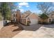 Charming two-story home with an attached garage, complemented by lush greenery and an American flag at 110 Great Oaks Ln, Roswell, GA 30075