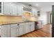 Well-lit kitchen featuring granite countertops, white cabinets, and stainless steel appliances at 110 Great Oaks Ln, Roswell, GA 30075