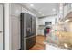 Stainless steel refrigerator, white cabinets and granite countertops make this kitchen shine at 110 Great Oaks Ln, Roswell, GA 30075
