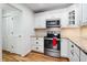 Modern kitchen equipped with stainless steel appliances, stylish white cabinetry, and ample counter space at 110 Great Oaks Ln, Roswell, GA 30075