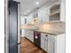 Bright kitchen with white cabinets, granite countertops and stainless steel appliances at 110 Great Oaks Ln, Roswell, GA 30075