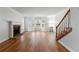 Spacious living room boasting hardwood floors, large windows, and a cozy fireplace with a mantel at 110 Great Oaks Ln, Roswell, GA 30075