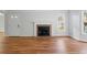 Bright living room featuring a classic fireplace, neutral paint, and expansive hardwood floors at 110 Great Oaks Ln, Roswell, GA 30075