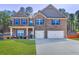 Charming two-story brick home with well-manicured lawn and attached two-car garage at 2695 Ridge Manor Drive, Dacula, GA 30019