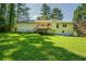 Exterior view of the back of a house, with a walkout basement and a wooden deck at 2811 Bay Leaf Se Dr, Conyers, GA 30094
