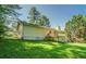 Exterior view of a yellow home, highlighting a well-maintained backyard with a small wooden deck at 2811 Bay Leaf Se Dr, Conyers, GA 30094