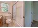 Bright bathroom with a toilet, bathtub, and shower with a window at 2811 Bay Leaf Se Dr, Conyers, GA 30094