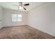 Bedroom featuring neutral carpeting, a ceiling fan, and a window at 2811 Bay Leaf Se Dr, Conyers, GA 30094