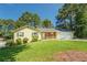 Inviting single-story home featuring a stone accent wall, a covered porch and green landscaping at 2811 Bay Leaf Se Dr, Conyers, GA 30094