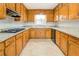 Galley style kitchen with wooden cabinets, a cooktop, and stone countertops at 2811 Bay Leaf Se Dr, Conyers, GA 30094